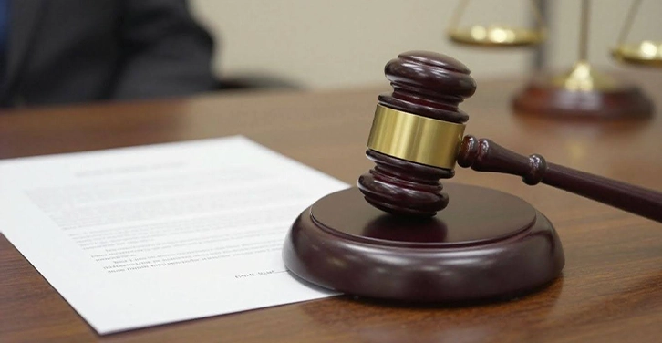 Gavel striking the judge's bench in the courtroom.